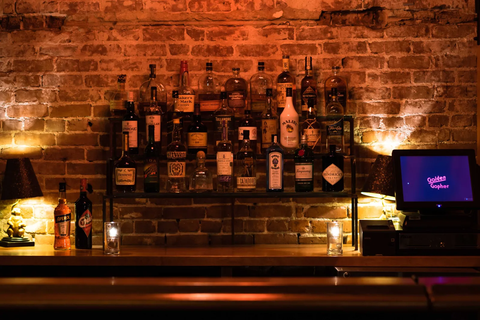 The back bar — bottles against original brick
