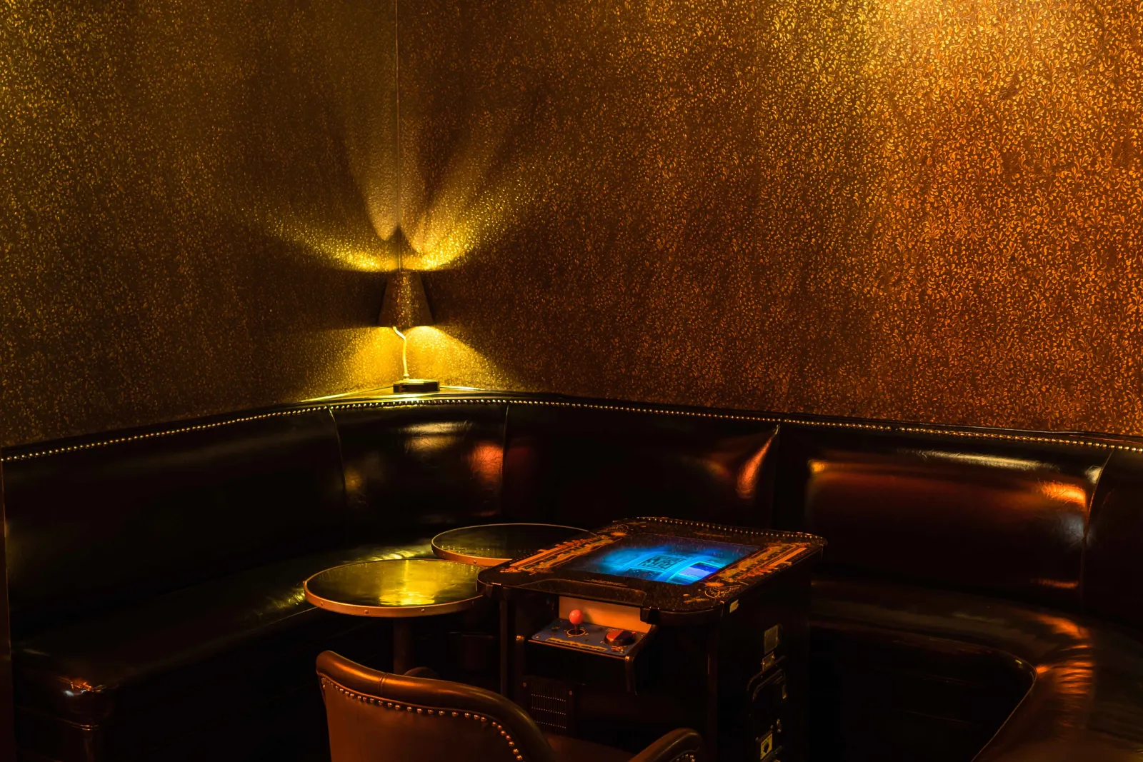 A leather corner booth under lamplight