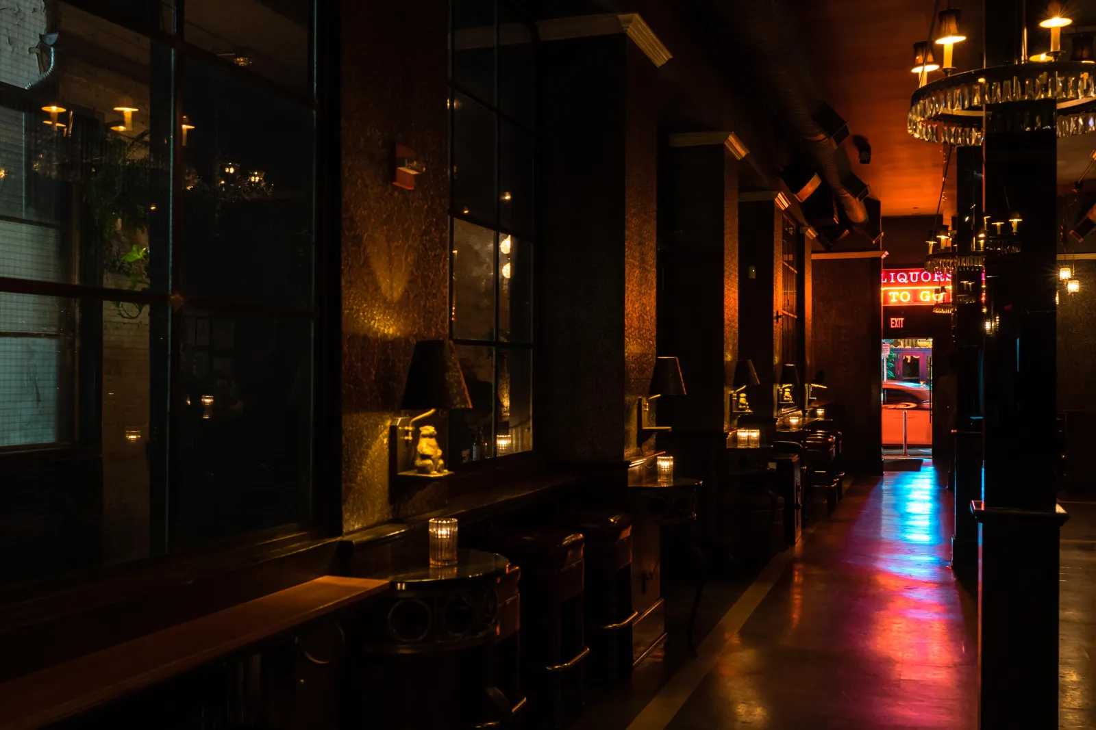 A booth by the patio windows, lit by candlelight