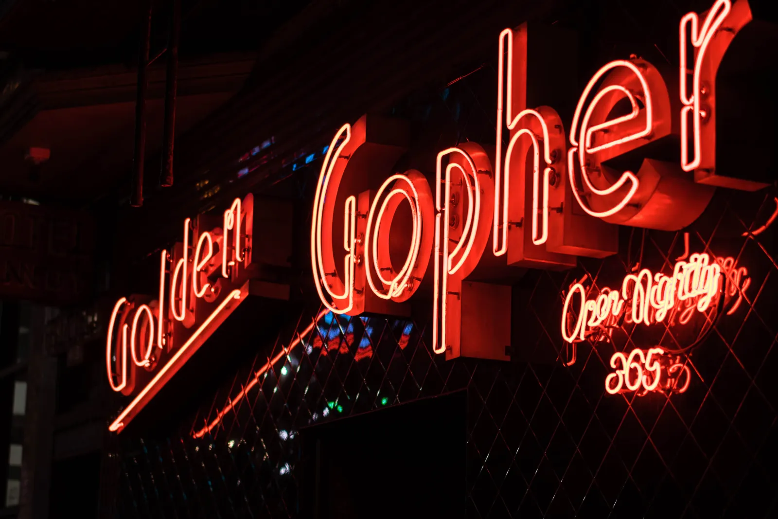 The Golden Gopher neon sign glowing red at night