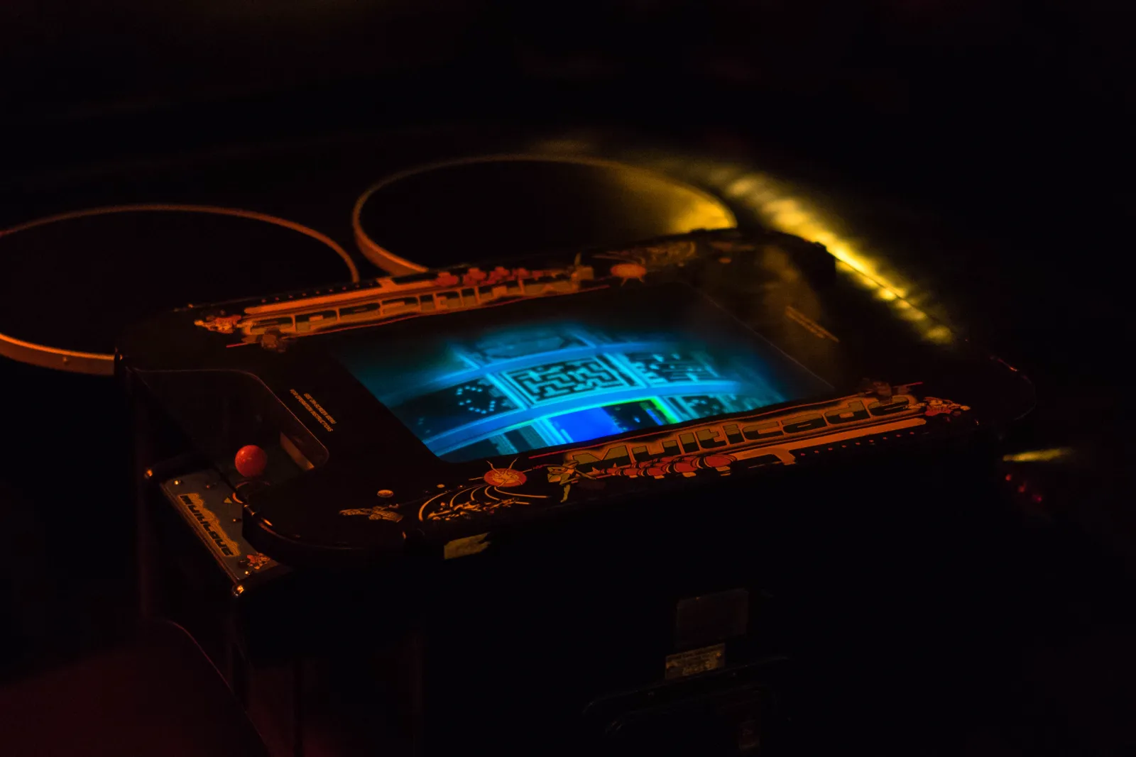 A vintage cocktail arcade table glowing in the dark