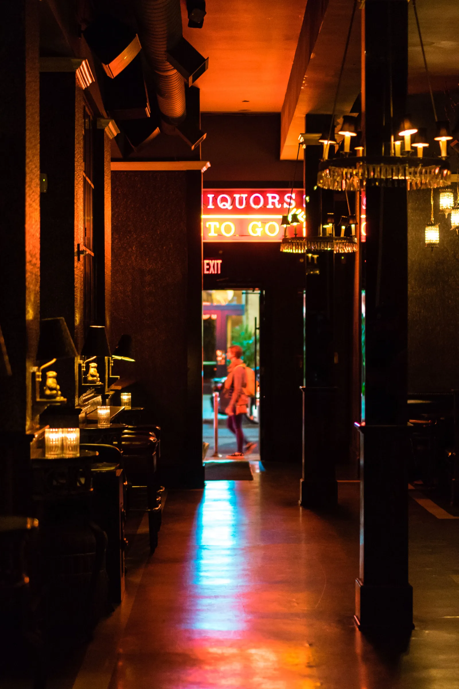 Booths and the Liquors To Go neon across the room
