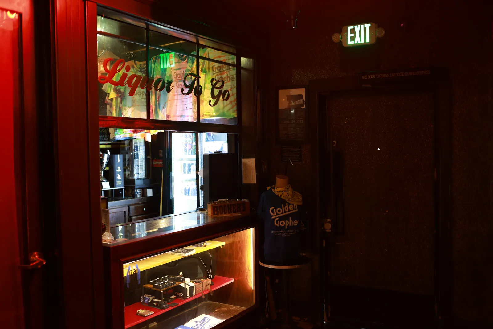 The Liquor To Go counter under its neon sign